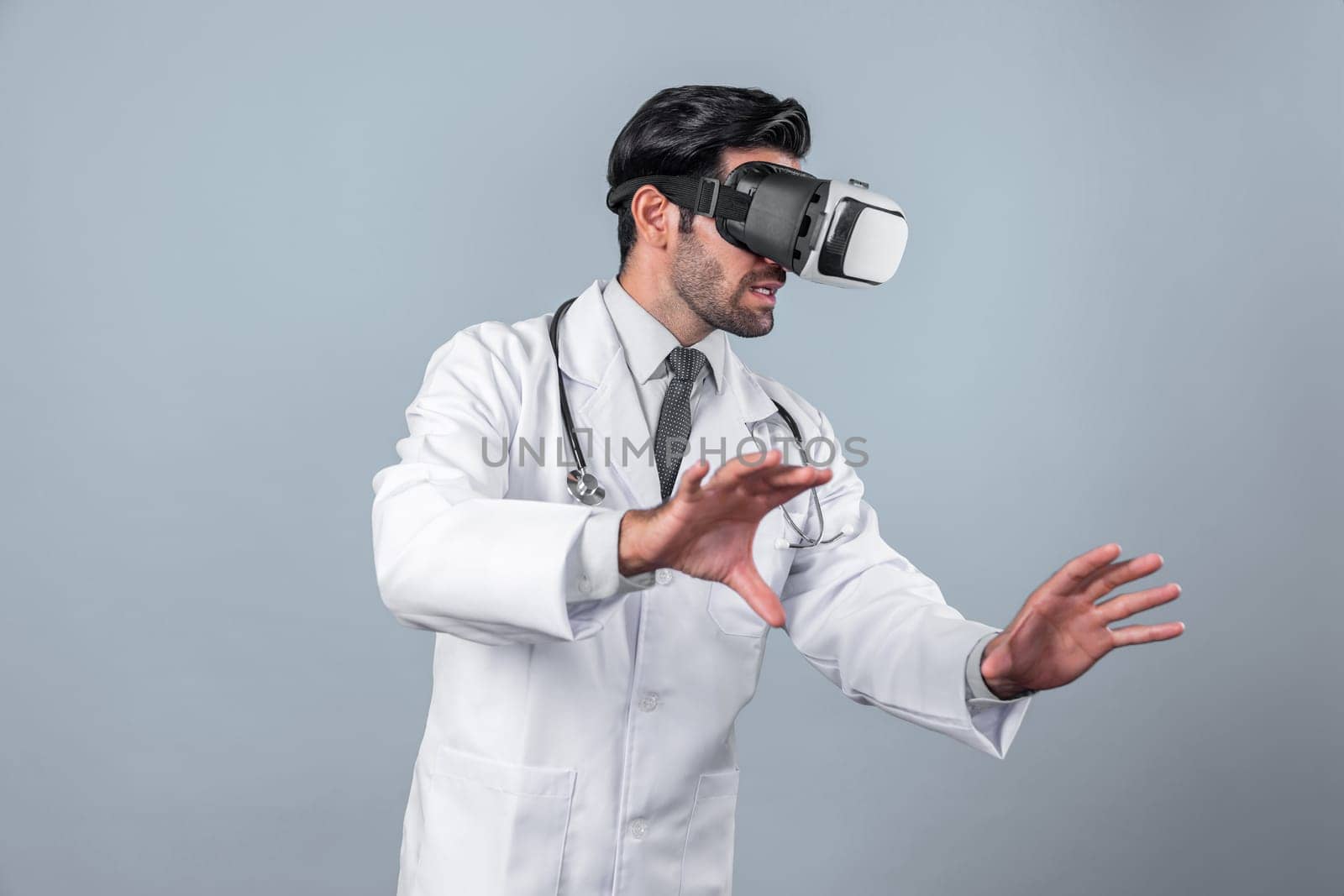 Caucasian smart doctor wearing VR goggles and lab coat while explaining medical theory. Professional doctor analysis medical data while connect metaverse by using visual reality headsets. Deviation.