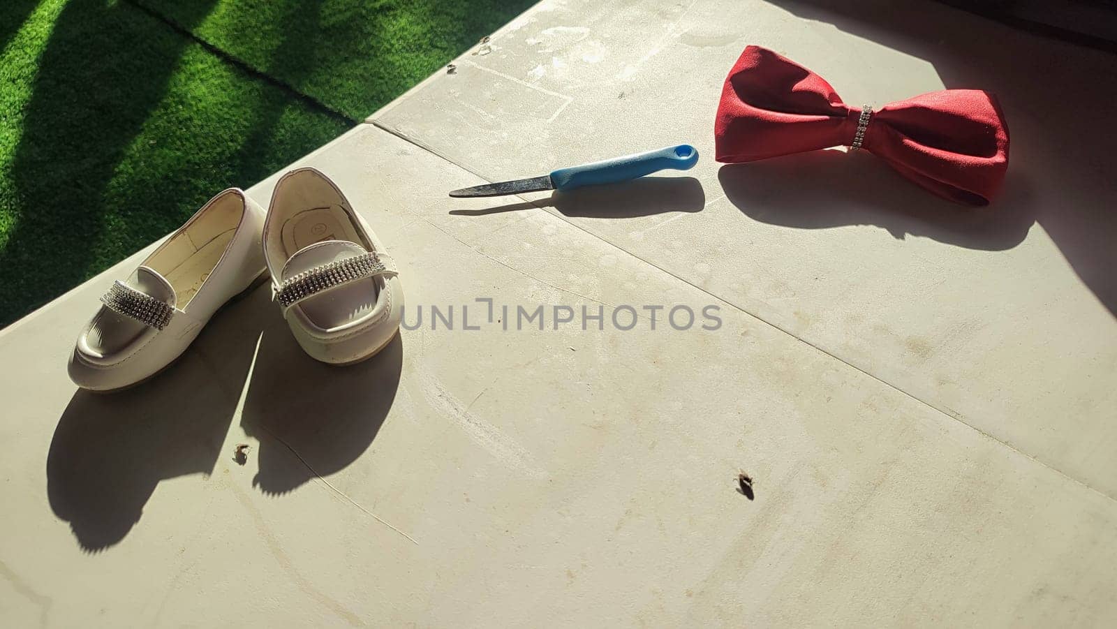 children's shoes, footwear objects knife, bow. High quality photo