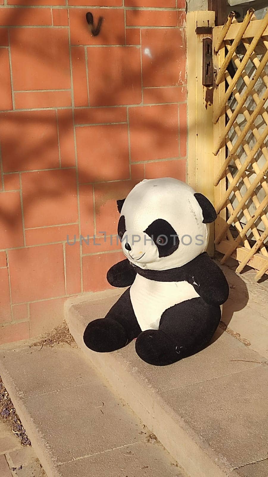 large soft children's toy panda bear thrown out on the street. High quality photo