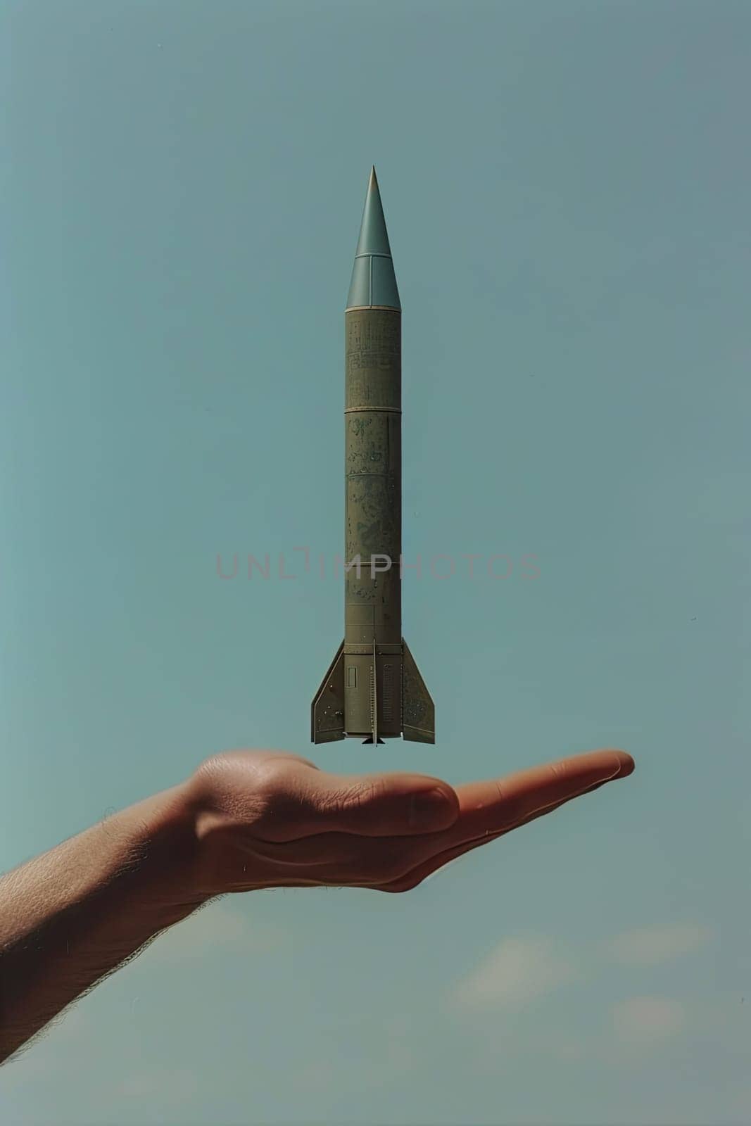 A man's hand holds a rocket. Selective focus. Nature.