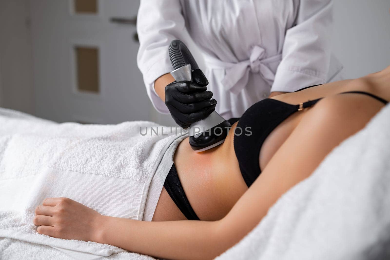 Client undergoes vacuum to facilitate removal of liquefied fat cells. Salon provides aesthetic techniques to achieve slimmer abdominal profile