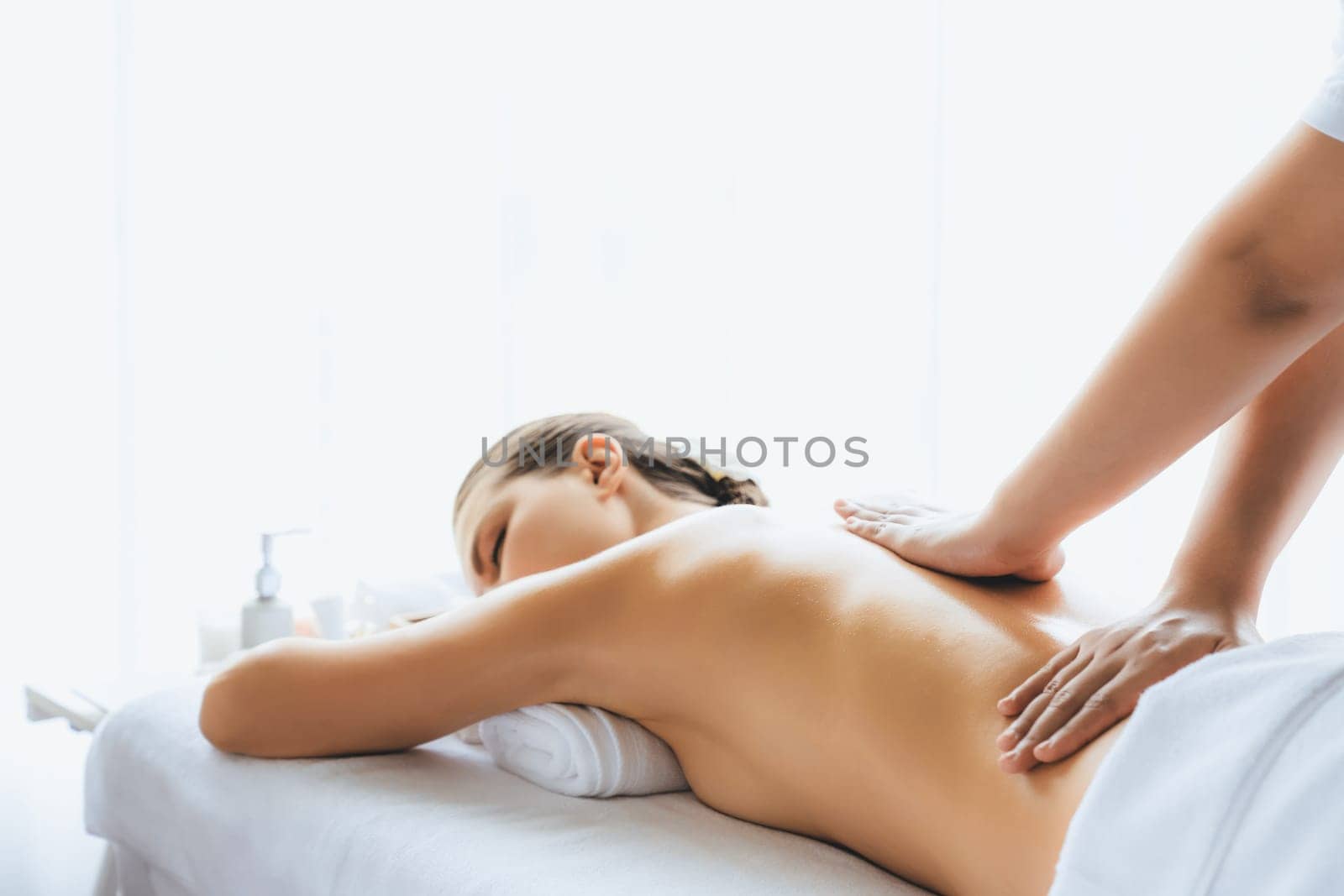 Caucasian woman customer enjoying relaxing anti-stress massage. Quiescent by biancoblue