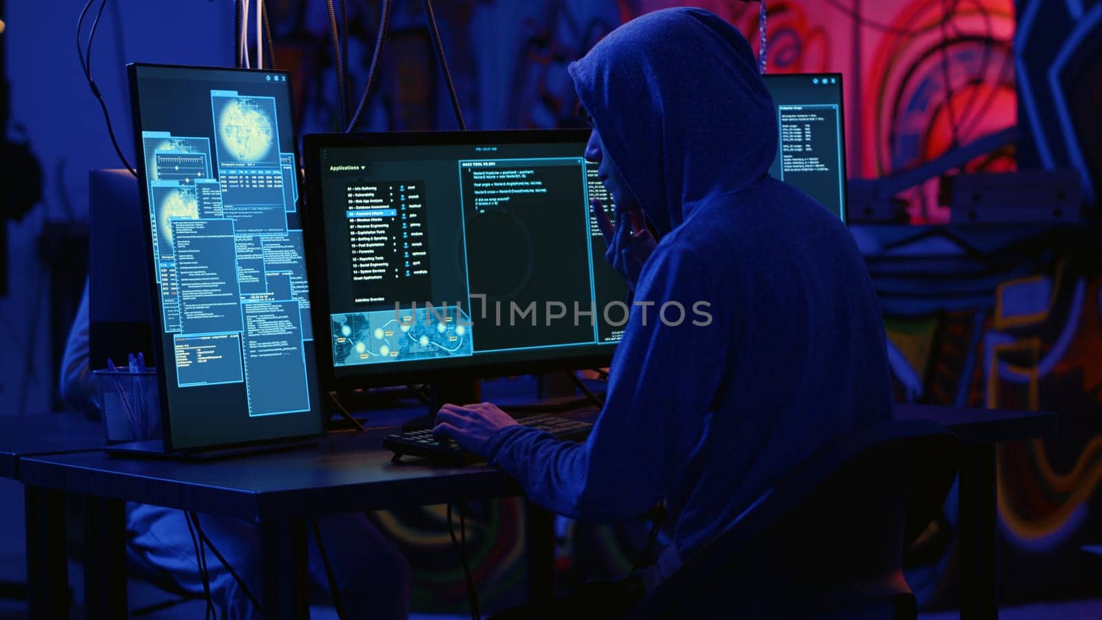 Hackers in dark room running code to breach defenses and exploit weaknesses in computer systems. Evil developers in basement getting past companies security networks, handheld camera shot