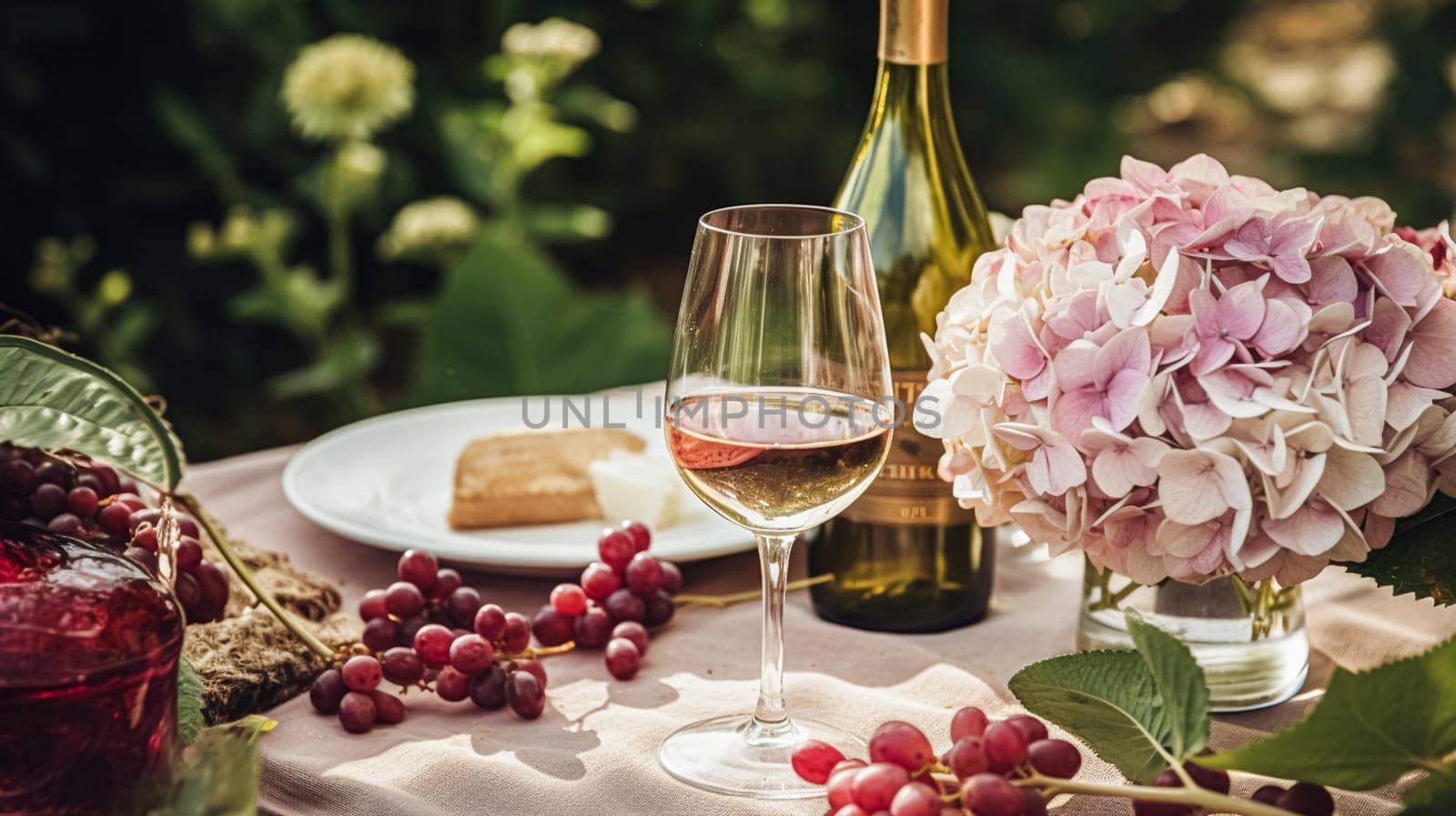 Wedding or formal dinner holiday celebration tablescape with hydrangea flowers in the English countryside garden, table setting and wine, floral table decor for family dinner party, home styling inspiration