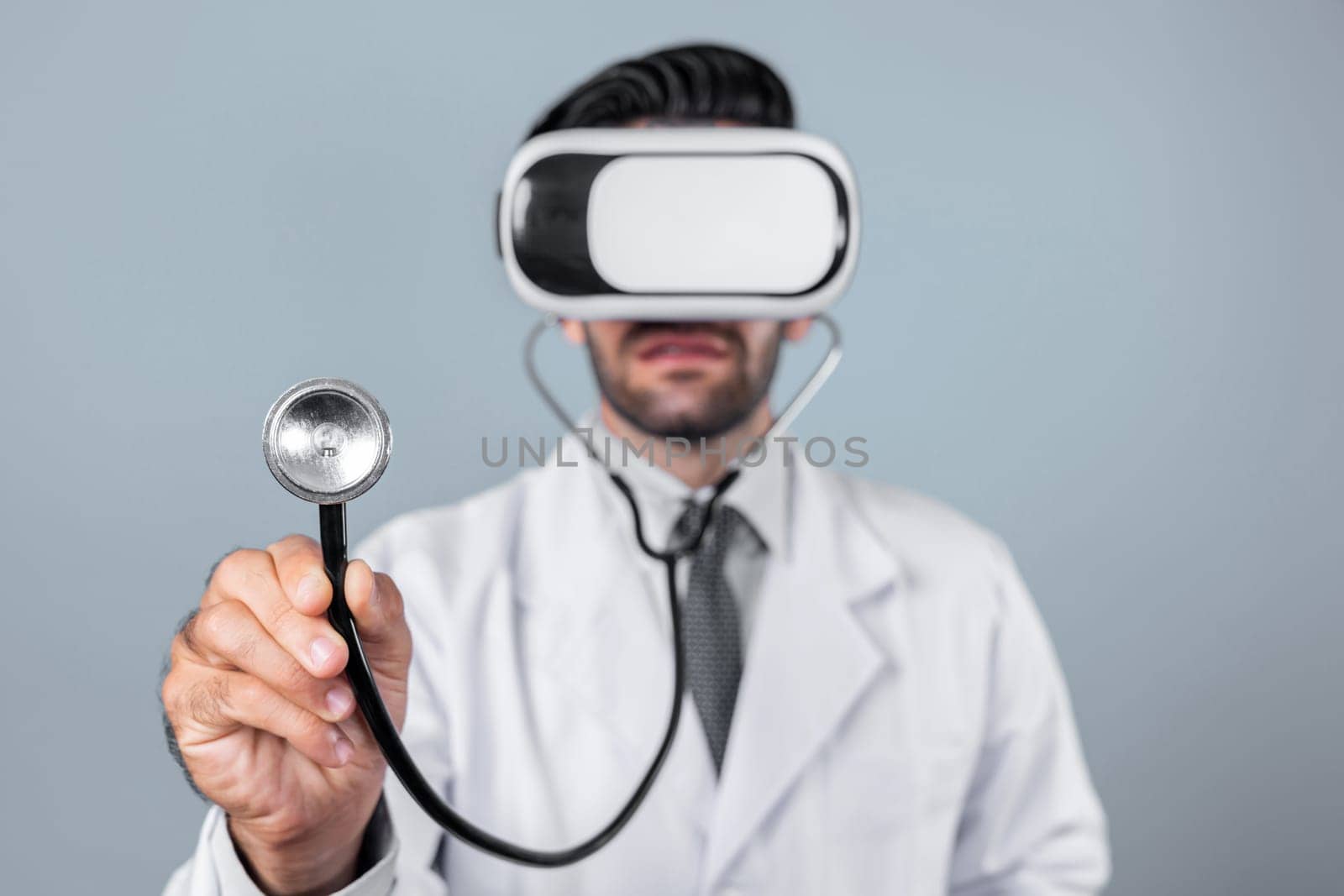 Skilled doctor wear VR glasses and lab coat while hold stethoscope for diagnosis disease. Caucasian doctor looking medical data from virtual reality goggles device. Innovation technology. Deviation.