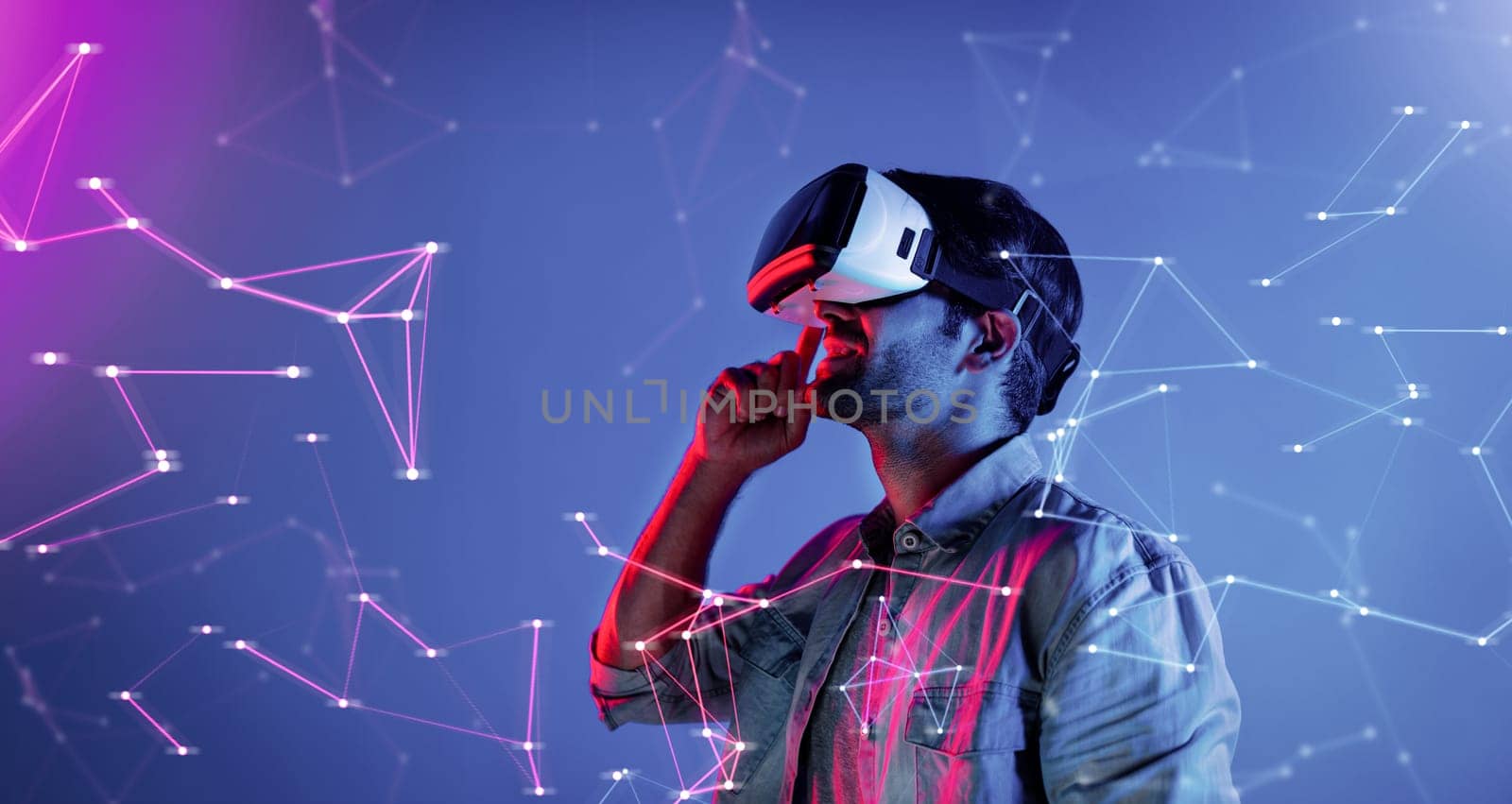 Smart caucasian man wearing VR glasses while standing at neon light. Skilled person using visual reality goggle to connect metaverse or visual world program by using technology innovation. Deviation.