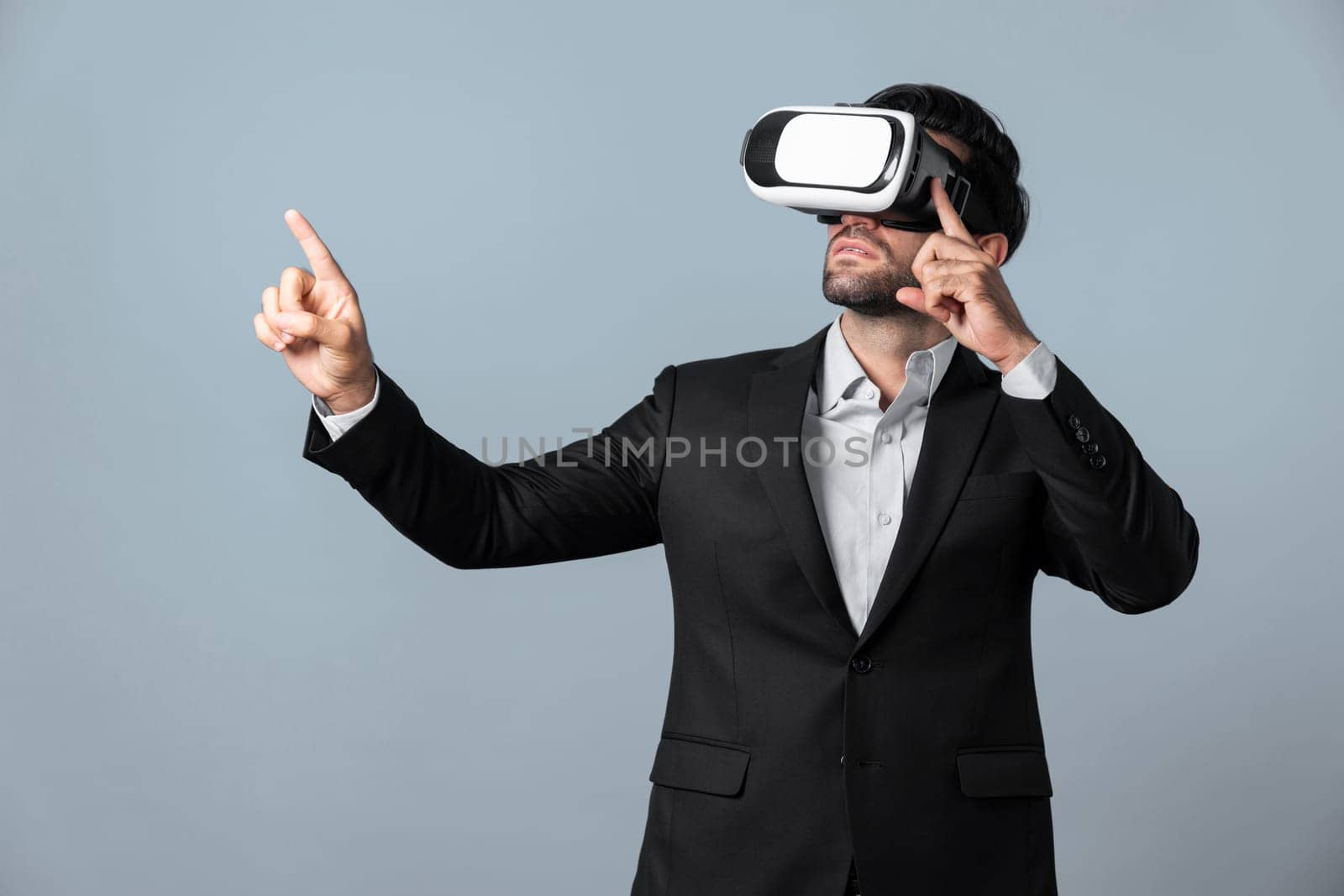 Smart business man holding something while touching VR goggle. Project manager planning marketing strategy while using visual reality headset to connect metaverse. Technology innovation. Deviation.