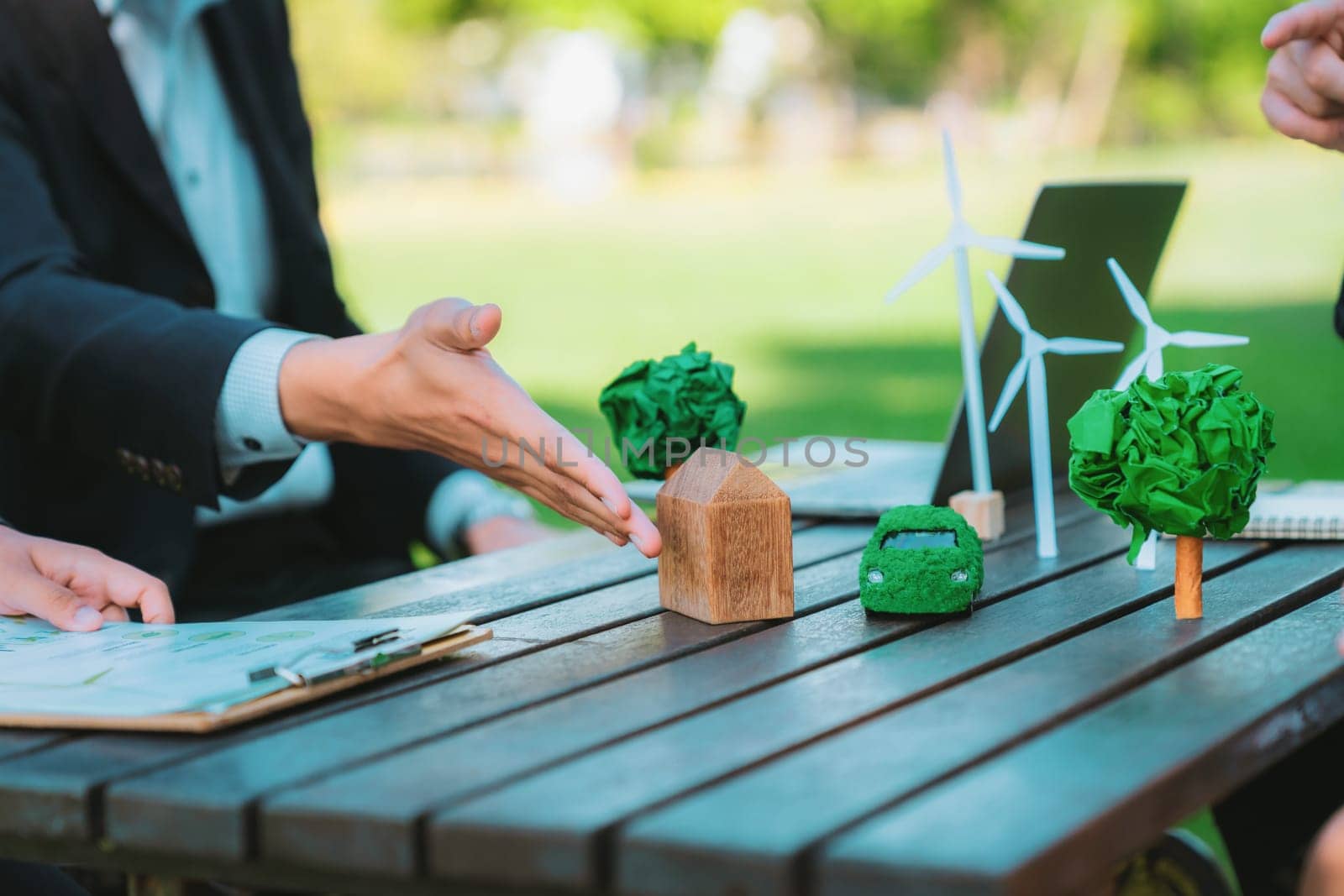 Group of asian business people presenting environmentally friendly development plan and sustainable technology project for greener future, establishing outdoor eco business office at natural park.Gyre