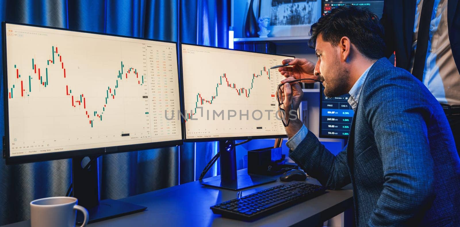 Stock exchange traders looking on high profit chart investment in panorama view, analyzing on monitor at night. Concept of discussing financial technology growth in neon light at workplace. Sellable.