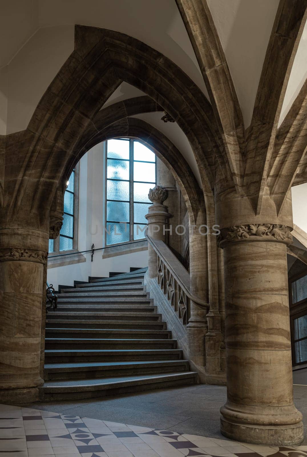 Munich, Germany - Dec 21, 2023 - Gothic architectural style with arches of famous New Town Hall (Neues Rathaus) on Marienplatz square in Munich. Beautiful Staircase with Ceiling, Pillars and windows, Space for text, Selective focus.