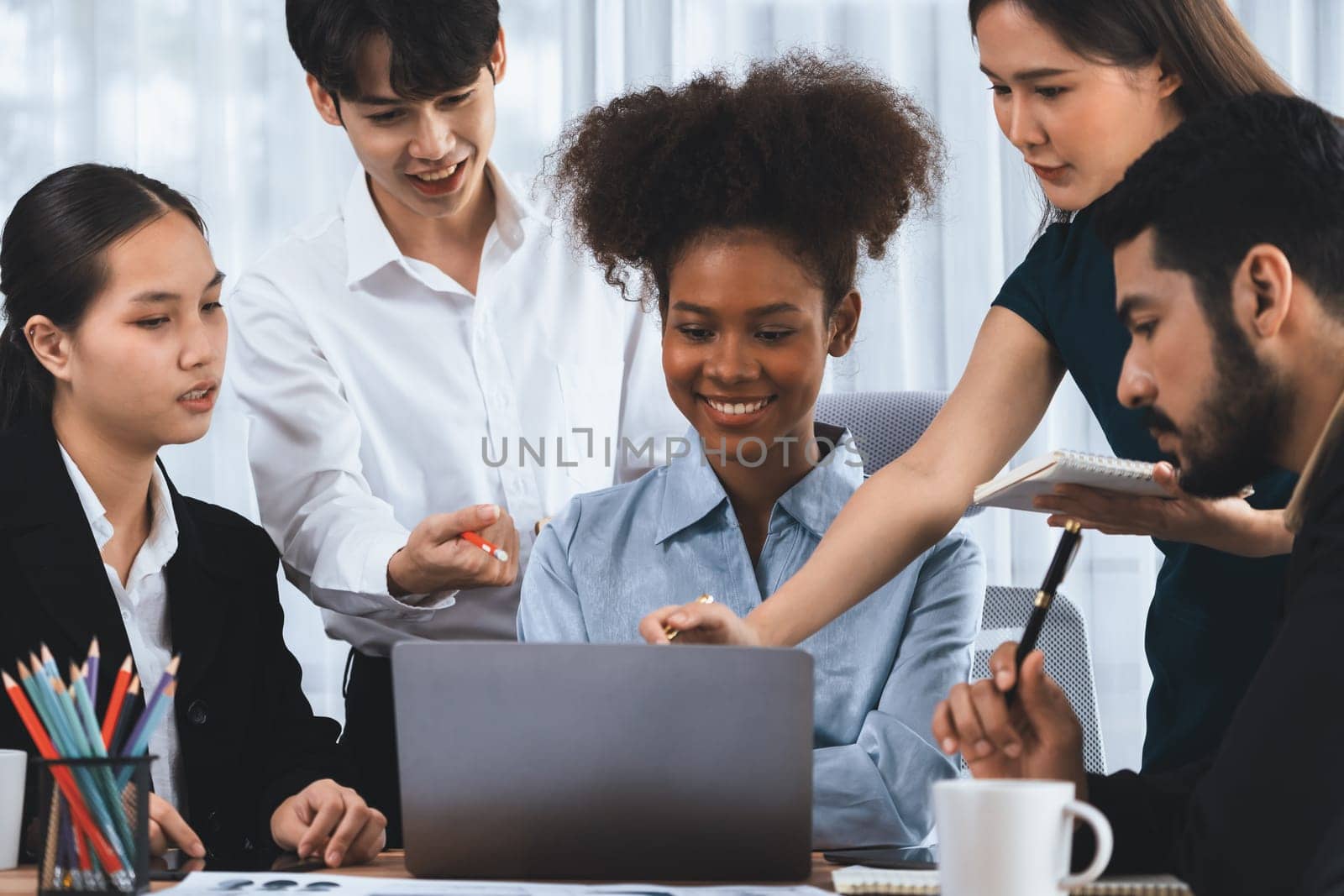 Happy diverse business people work together, discussing in corporate office. Professional and diversity teamwork discuss business plan on desk with laptop. Modern multicultural office worker. Concord