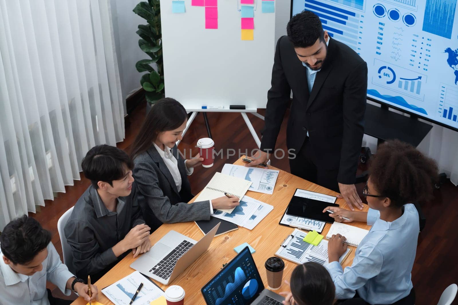 Top view business presentation with data analysis dashboard on TV screen in modern meeting room. Business people brainstorming or working together to plan business marketing strategy. Concord