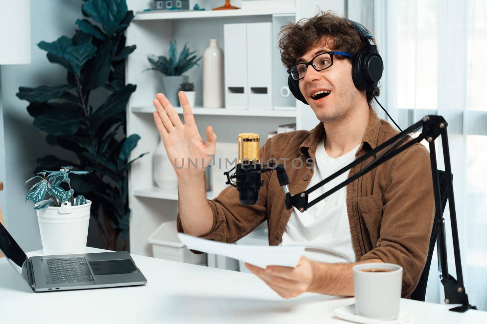 Host channel of influencer using headphone and mic talking with listeners on social media with laptop in life coaching and training marketing planning to customer target at studio office. Gusher.