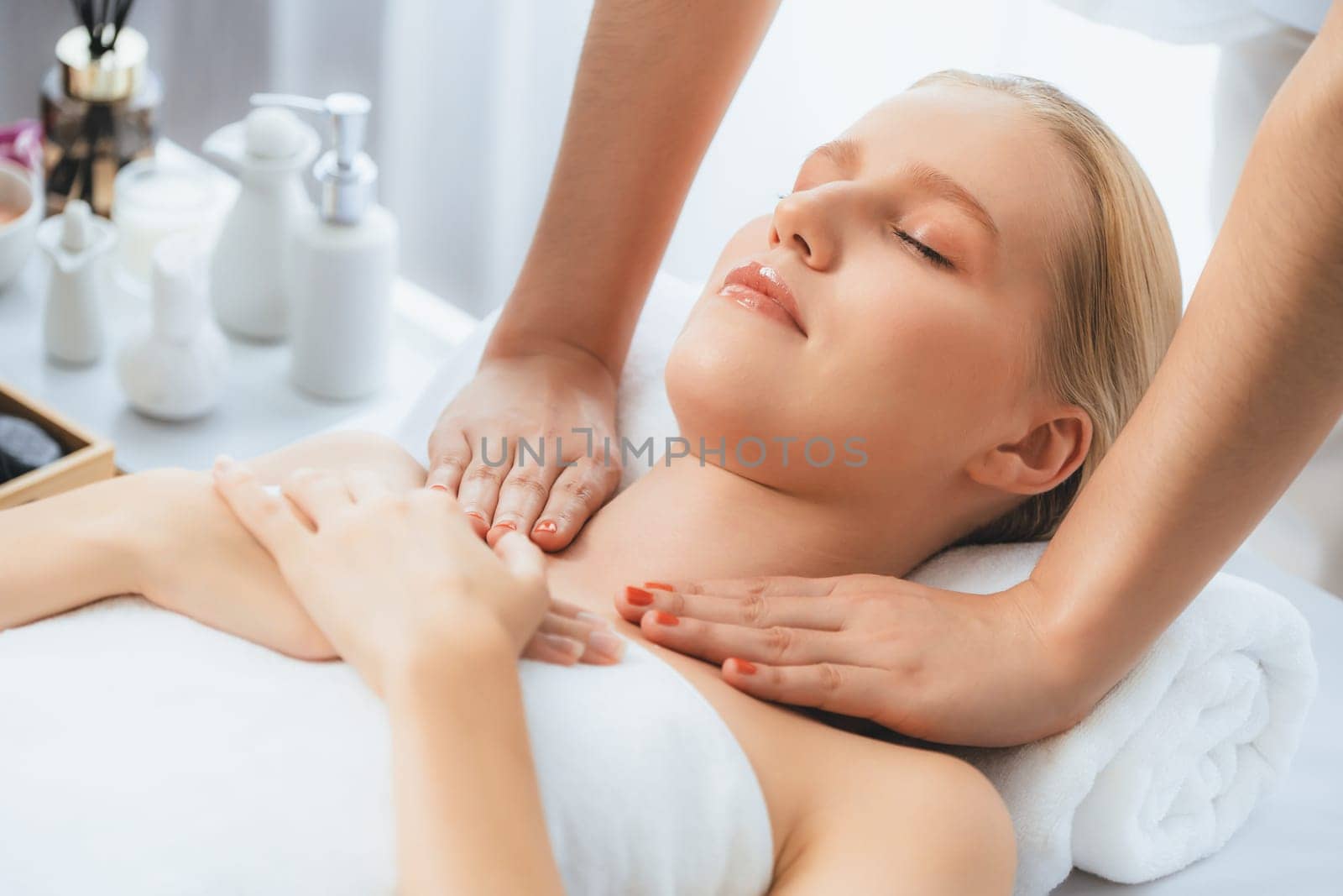 Caucasian woman customer enjoying relaxing anti-stress spa massage and pampering with beauty skin recreation leisure in day light ambient salon spa at luxury resort or hotel. Quiescent