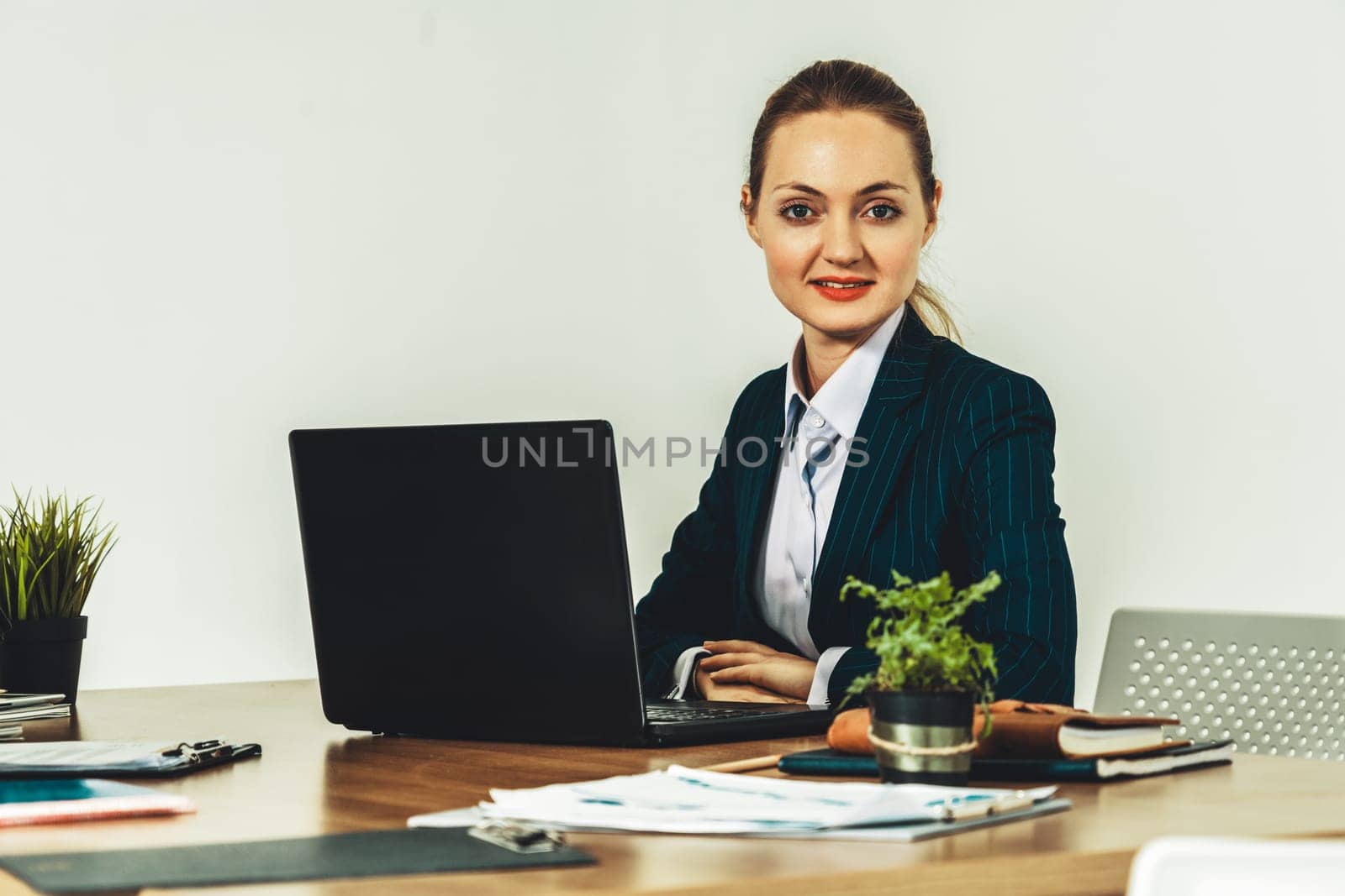 Young attractive businesswoman CEO executive working with laptop computer in office. uds