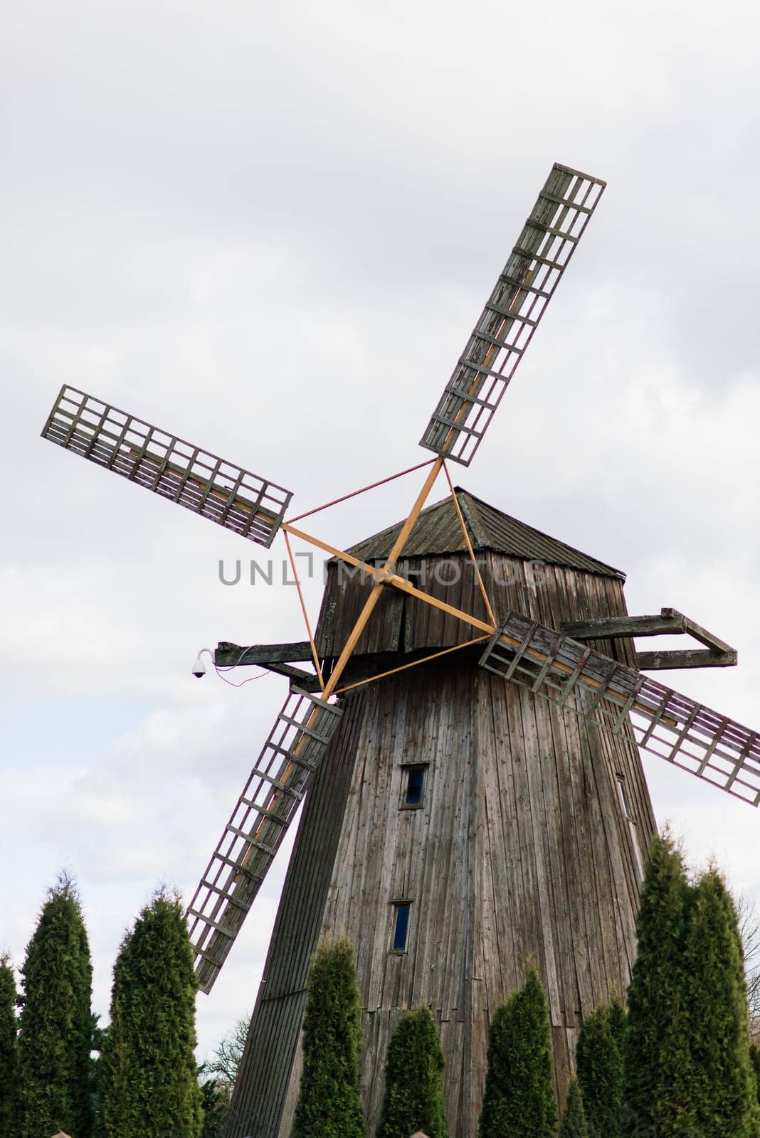 Old wooden wind mill in on sunny day. Old traditional Dutch mill.