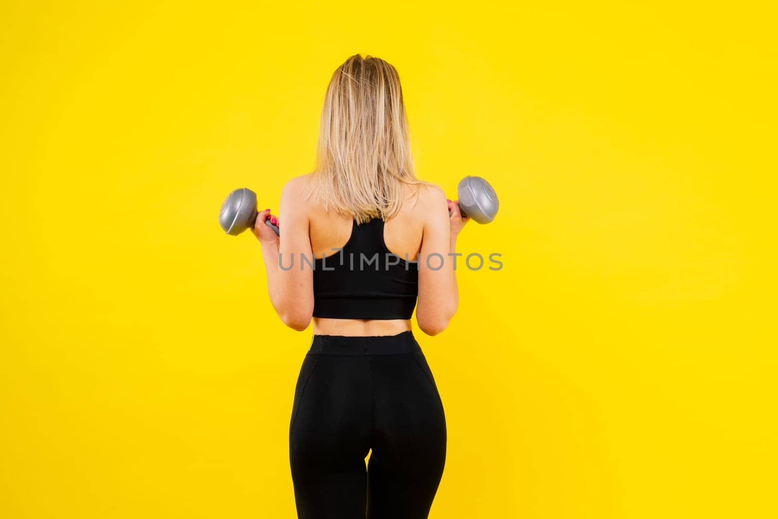 Middle aged woman doing fitness workout, standing in activewear with abs and muscles, smiling happy by Zelenin