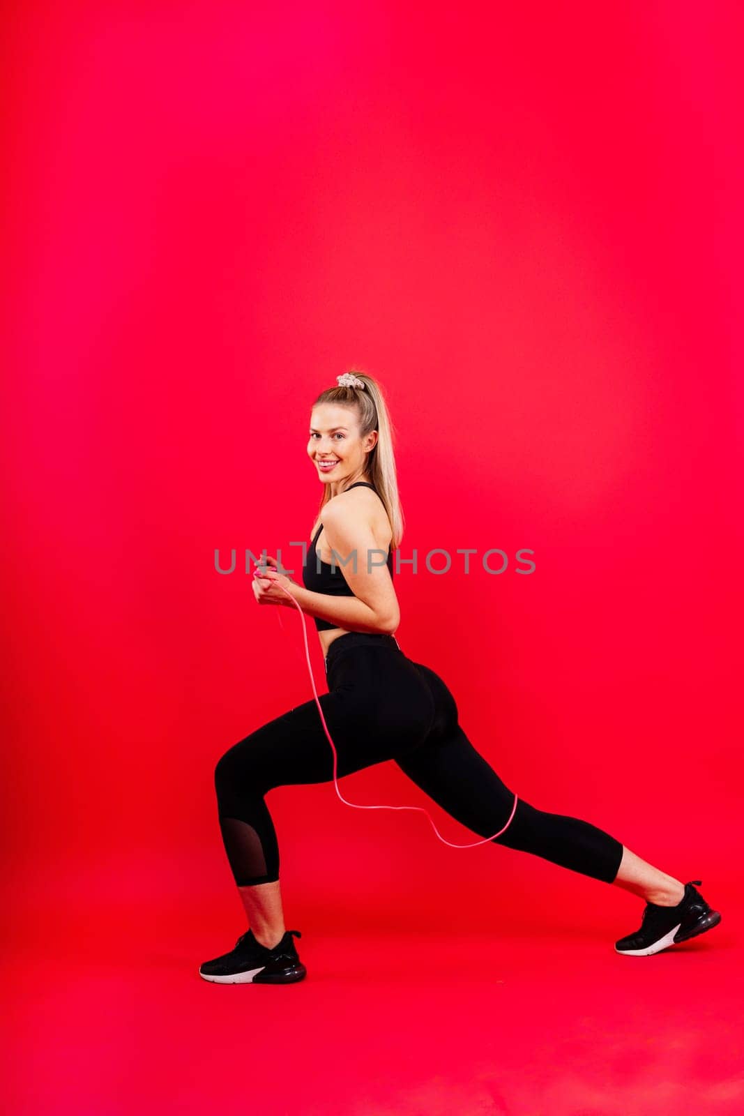 Middle aged woman doing fitness workout, standing on activewear with abs and muscles, smiling happy