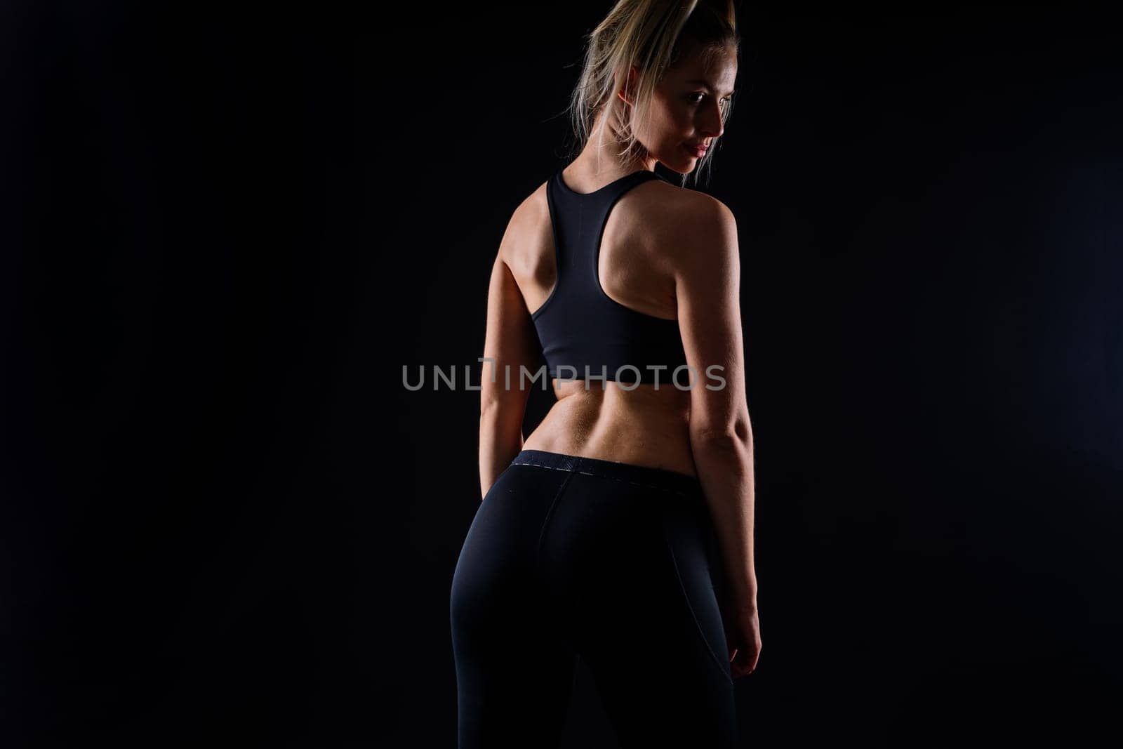 Middle aged woman doing fitness workout, standing on activewear with abs and muscles, smiling happy