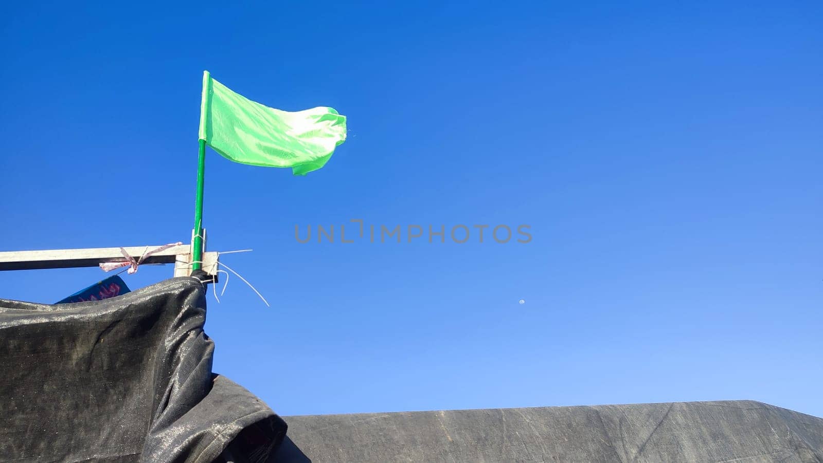 blue sky, Bedouin tent, green flag symbol of Palestine in the Negev desert, Israel. High quality photo