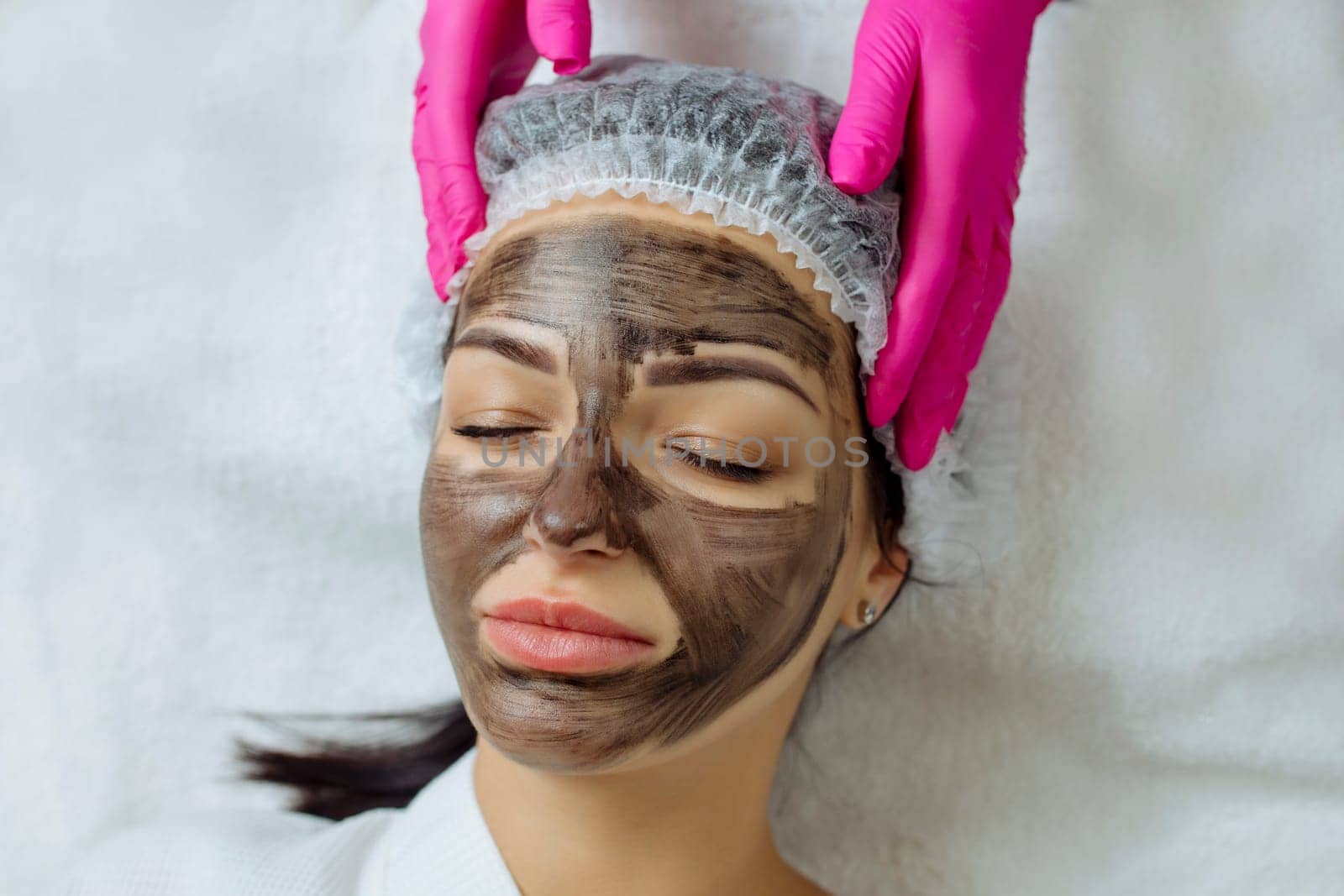 Close-up of carbon peeling procedure for middle-aged woman face. Laser pulses clean skin. Process of photothermolysis, warming, laser carbon peeling. Facial skin rejuvenation, cosmetology treatment