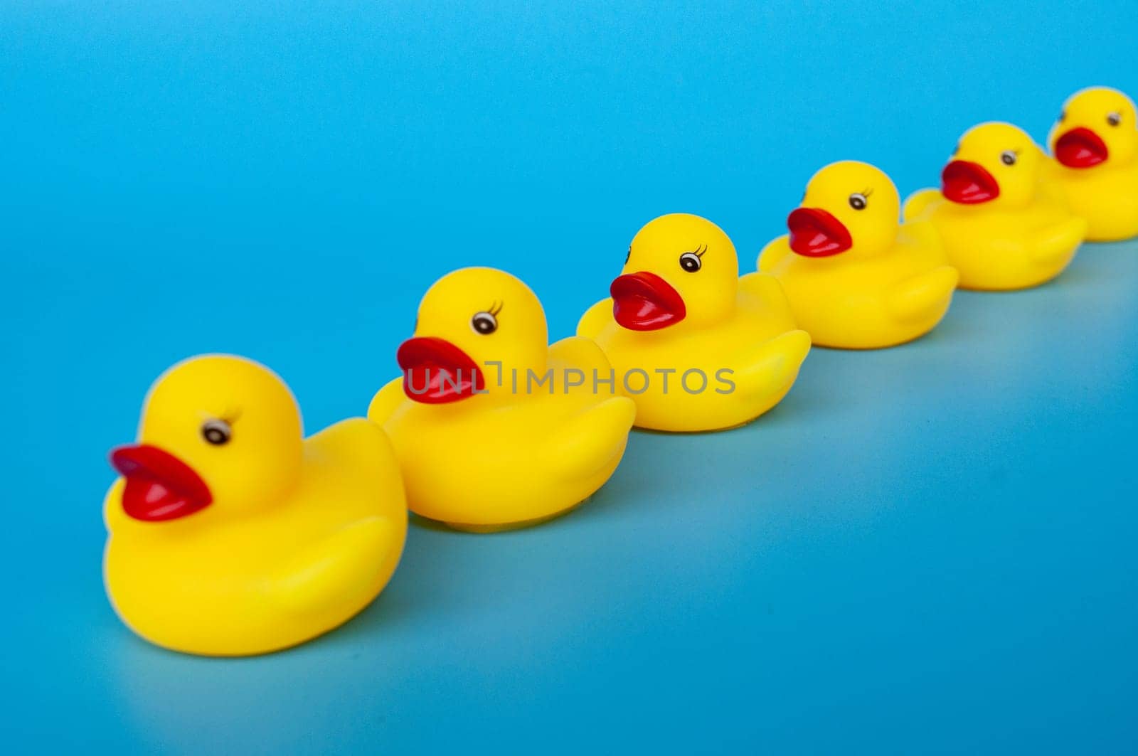 Side view of rubber ducks in line with customizable space for text.