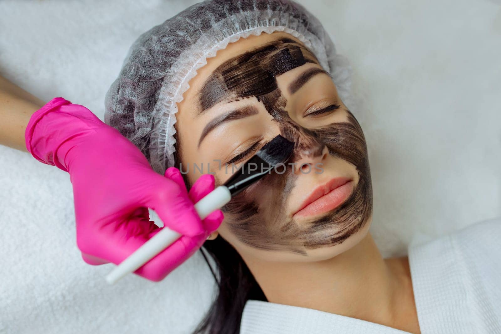Close-up of carbon peeling procedure for middle-aged woman face. Laser pulses clean skin. Process of photothermolysis, warming, laser carbon peeling. Facial skin rejuvenation, cosmetology treatment