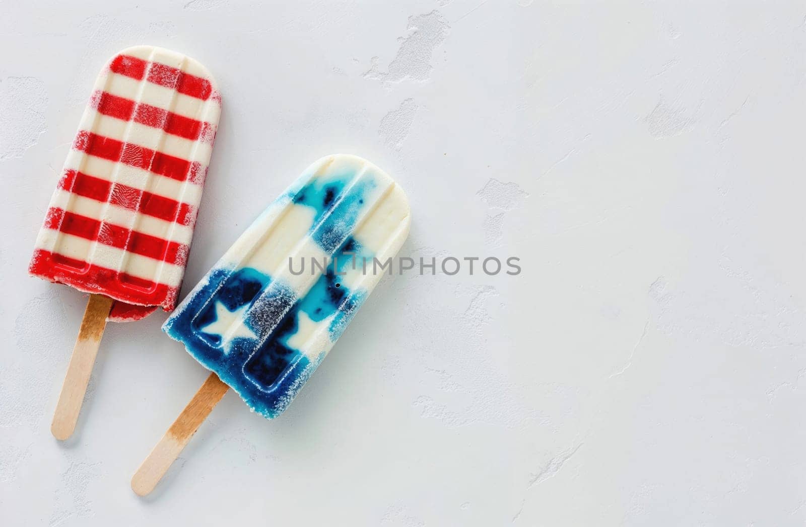 Red, blue and white popsicles on blue, top view, summer concept, space for text