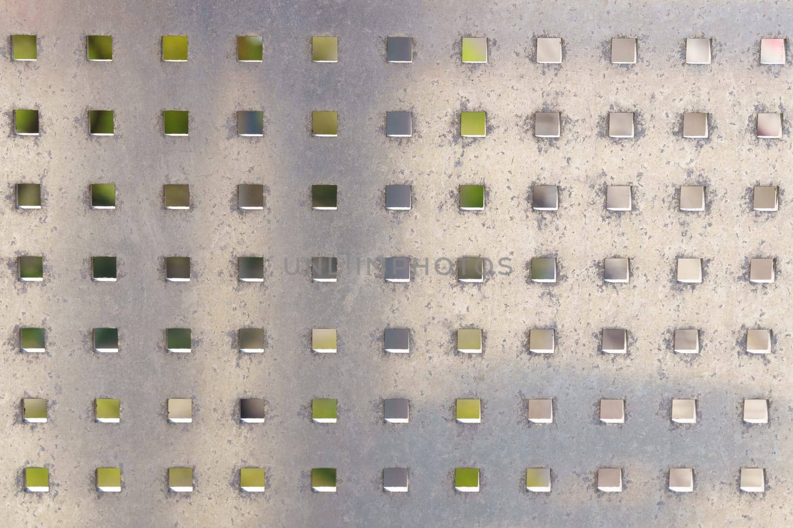 Detailed close-up of a metal plate with neatly arranged squares, showcasing texture and abstraction.