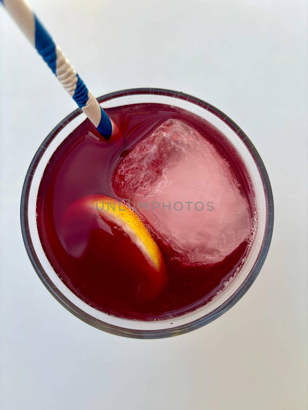 Glass of red sangria, Tinto de Verano, top view on white table by DailySF