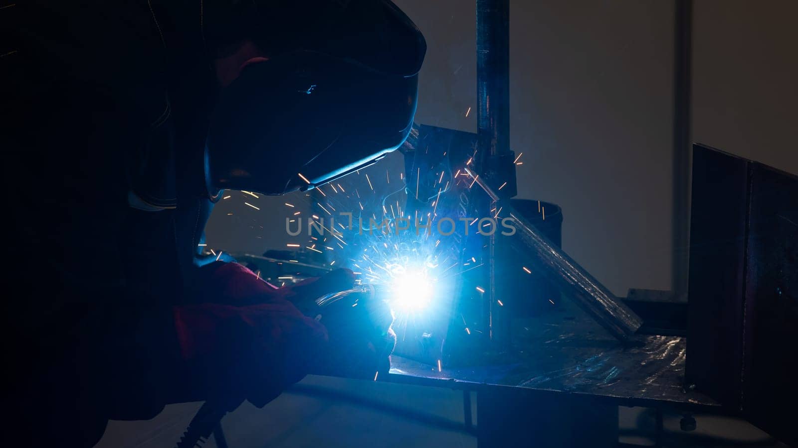 Competitions among welders. A man in a protective mask is welding. by mrwed54
