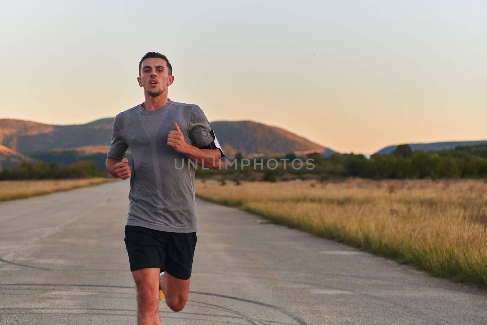 A young handsome man running in the early morning hours, driven by his commitment to health and fitness. High quality photo