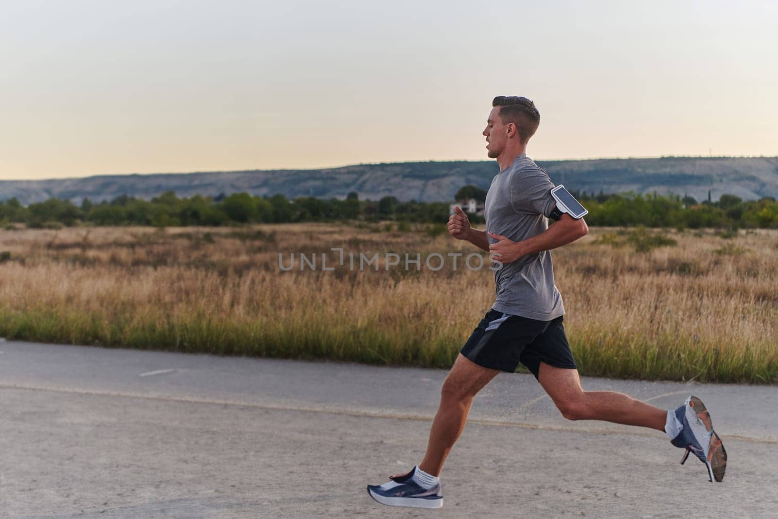 A young handsome man running in the early morning hours, driven by his commitment to health and fitness. High quality photo