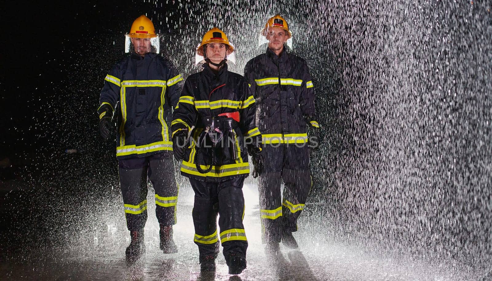 A group of professional firefighters marching through the rainy night on a rescue mission, their determined strides and fearless expressions reflecting their unwavering bravery and unwavering commitment to saving lives