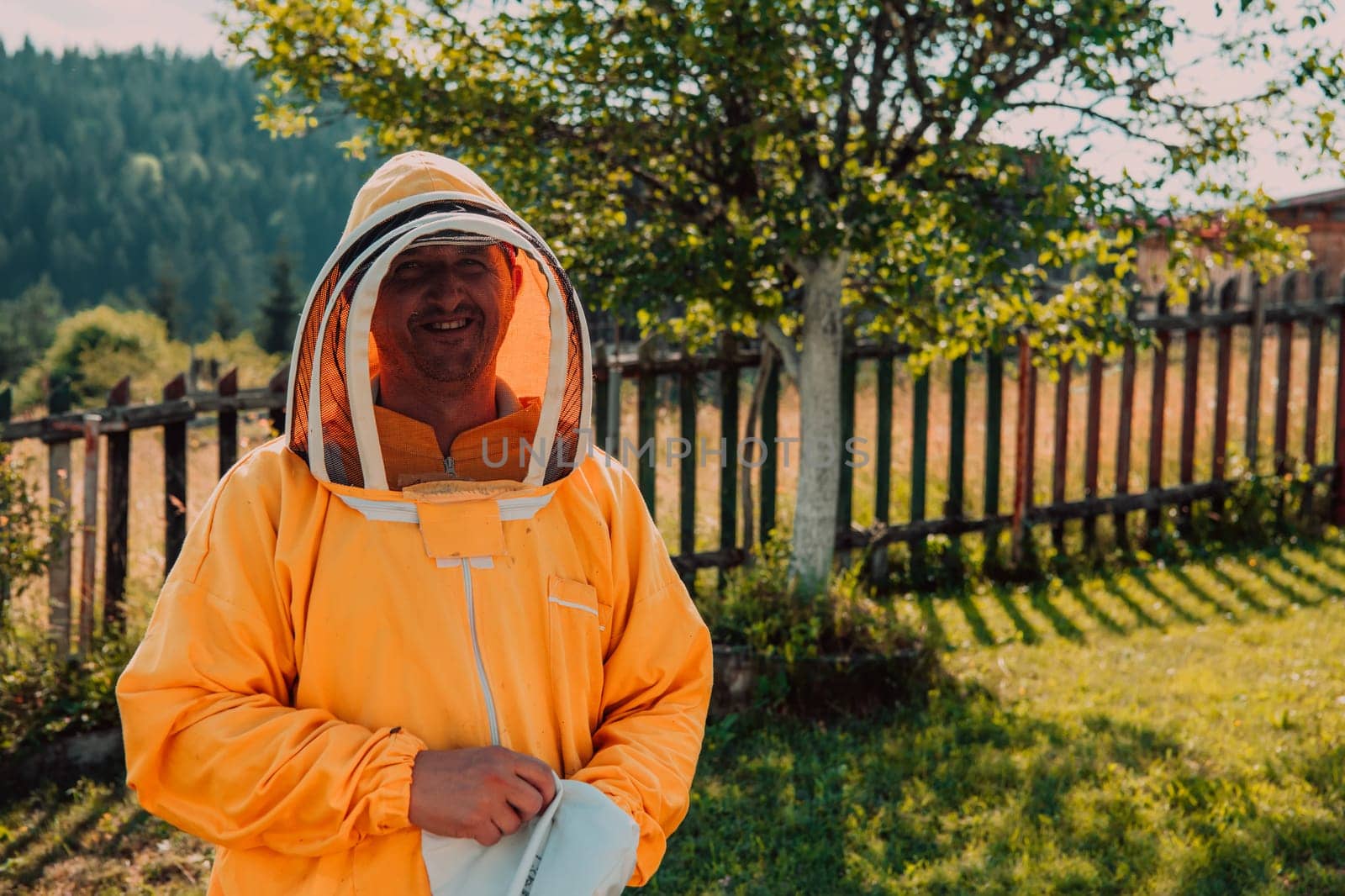 Beekeeper put on a protective beekeeping suit and preparing to enter the apiary.