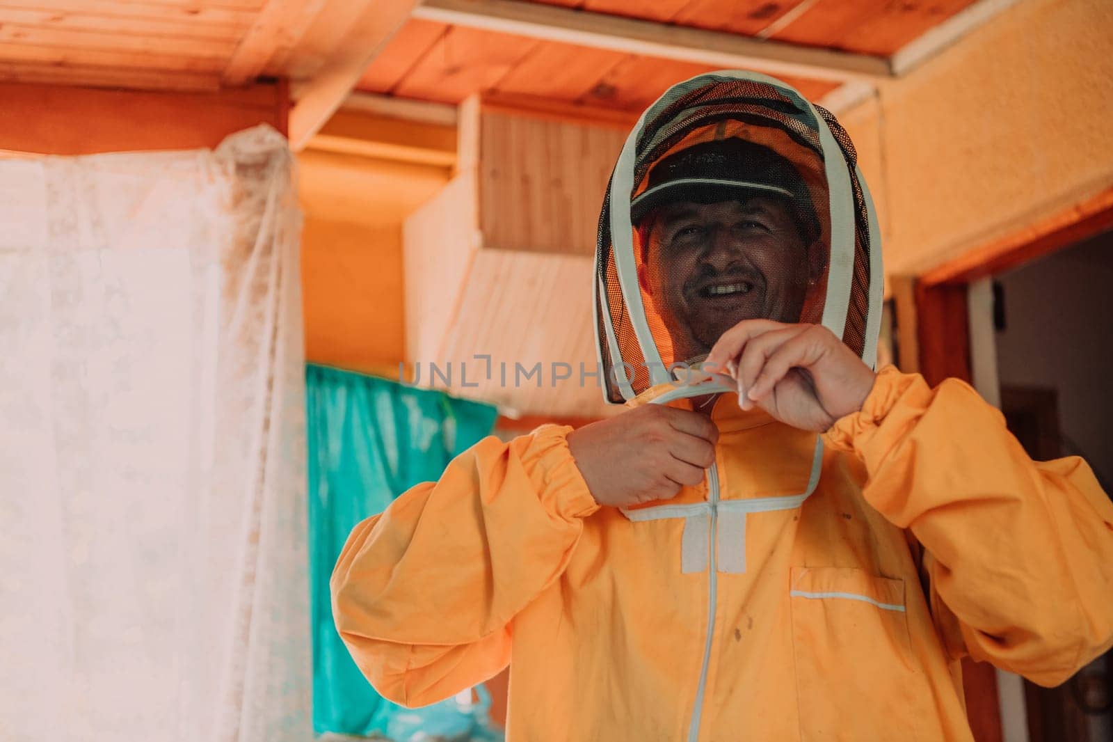 Beekeeper put on a protective beekeeping suit and preparing to enter the apiary.