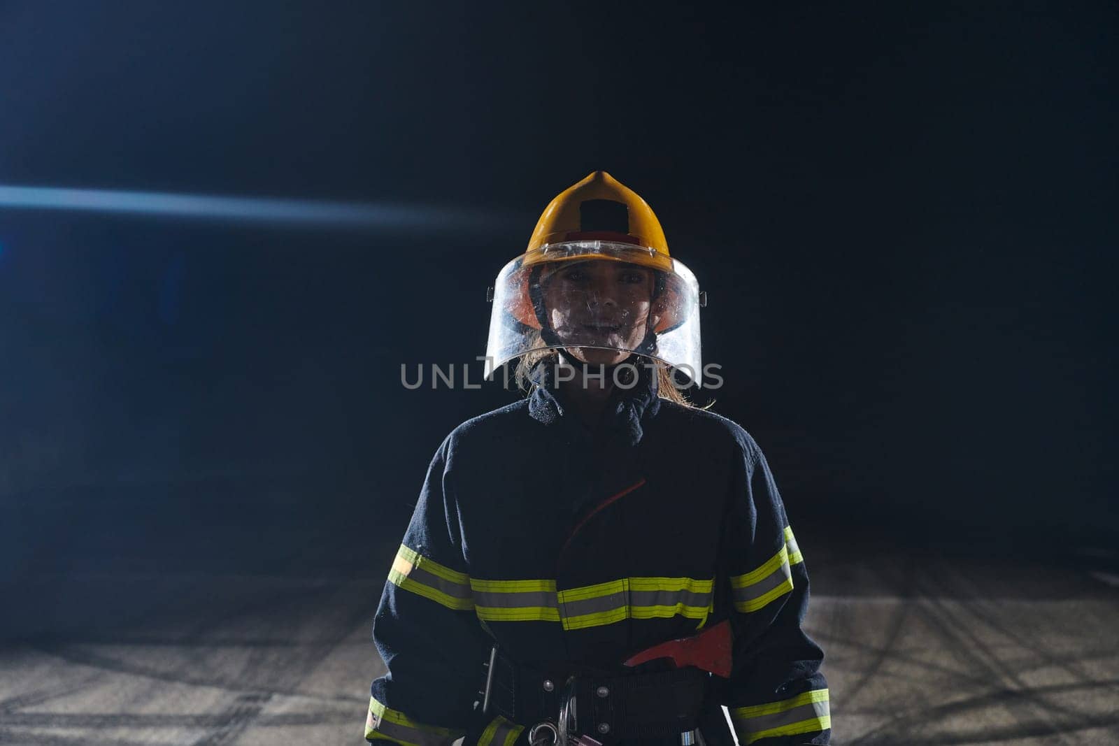 Portrait of a female firefighter standing and walking brave and optimistic.