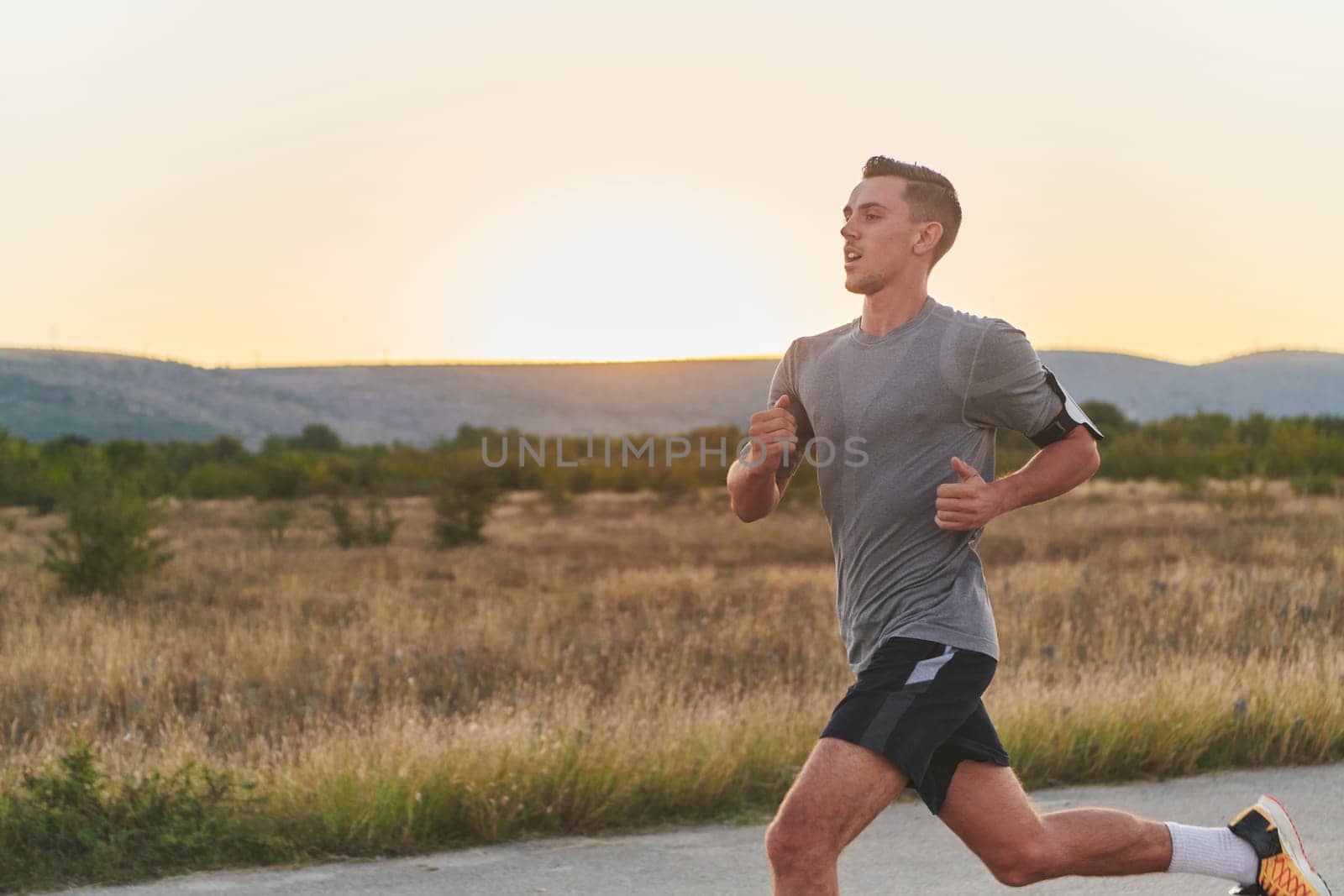 A young handsome man running in the early morning hours, driven by his commitment to health and fitness. High quality photo