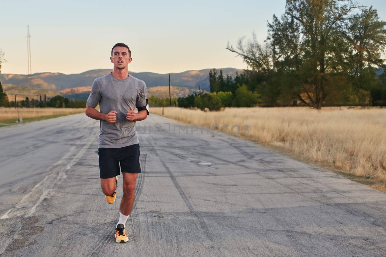 A young handsome man running in the early morning hours, driven by his commitment to health and fitness. High quality photo