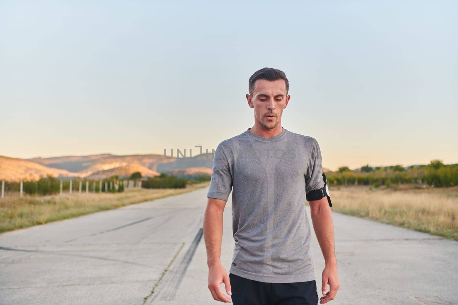 A young handsome man running in the early morning hours, driven by his commitment to health and fitness by dotshock