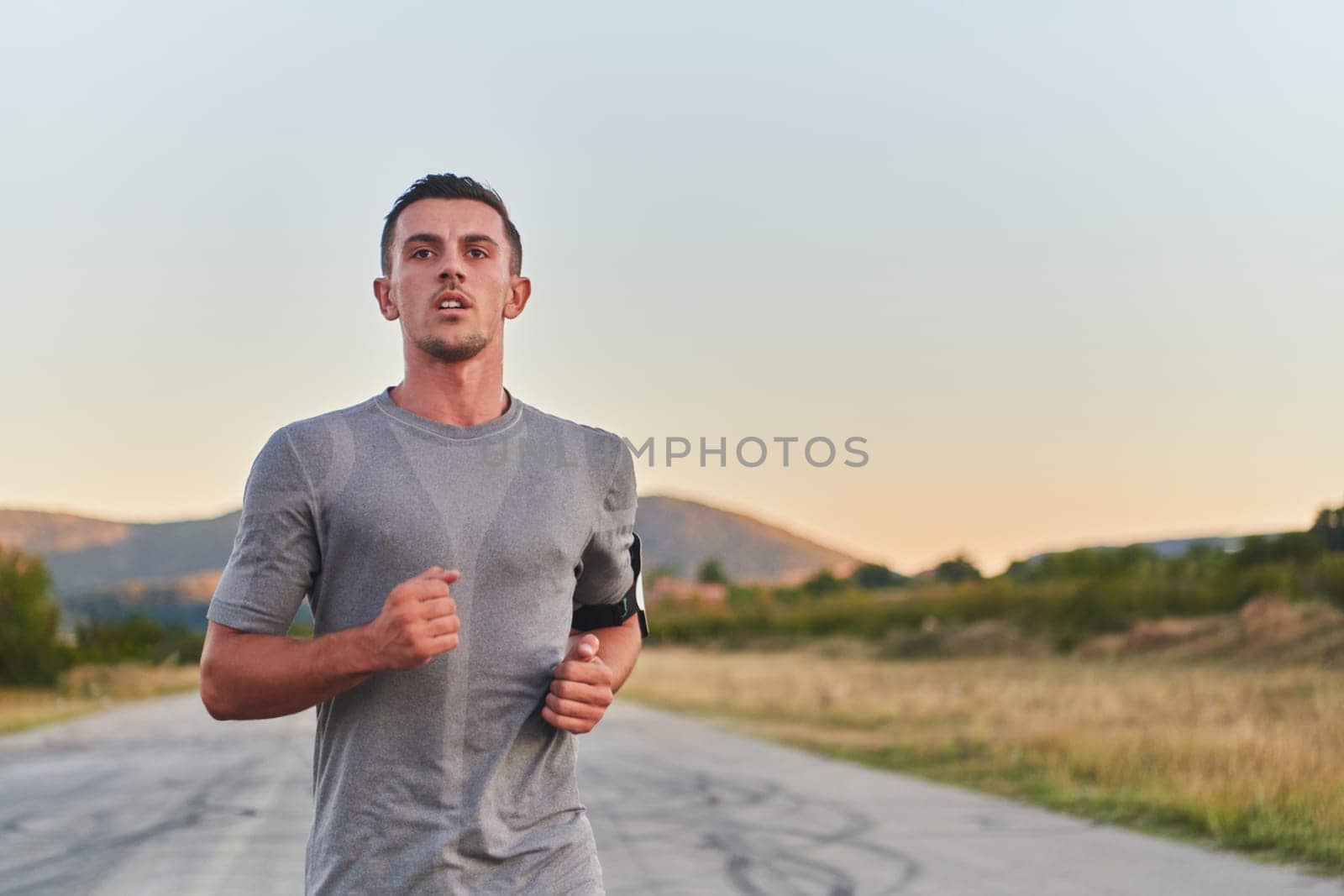 A young handsome man running in the early morning hours, driven by his commitment to health and fitness. High quality photo