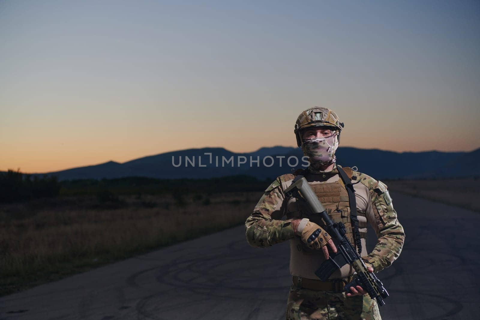 A professional soldier in full military gear striding through the dark night as he embarks on a perilous military mission.