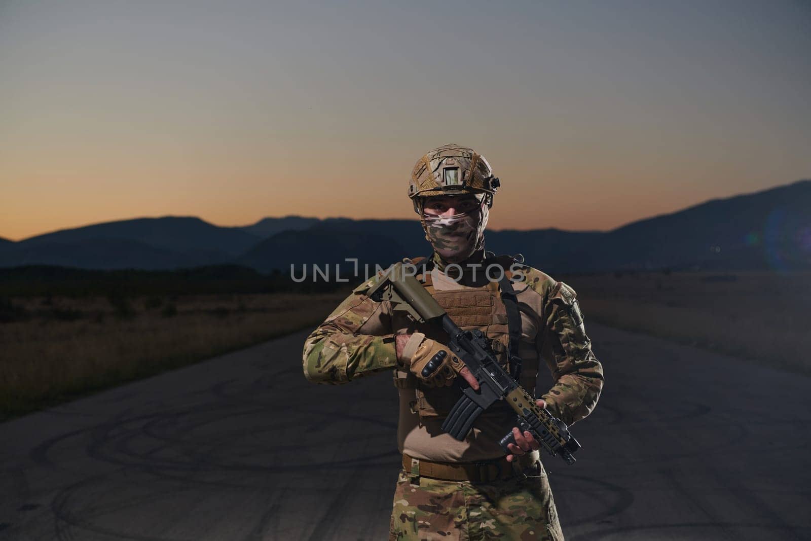 A professional soldier in full military gear striding through the dark night as he embarks on a perilous military mission.