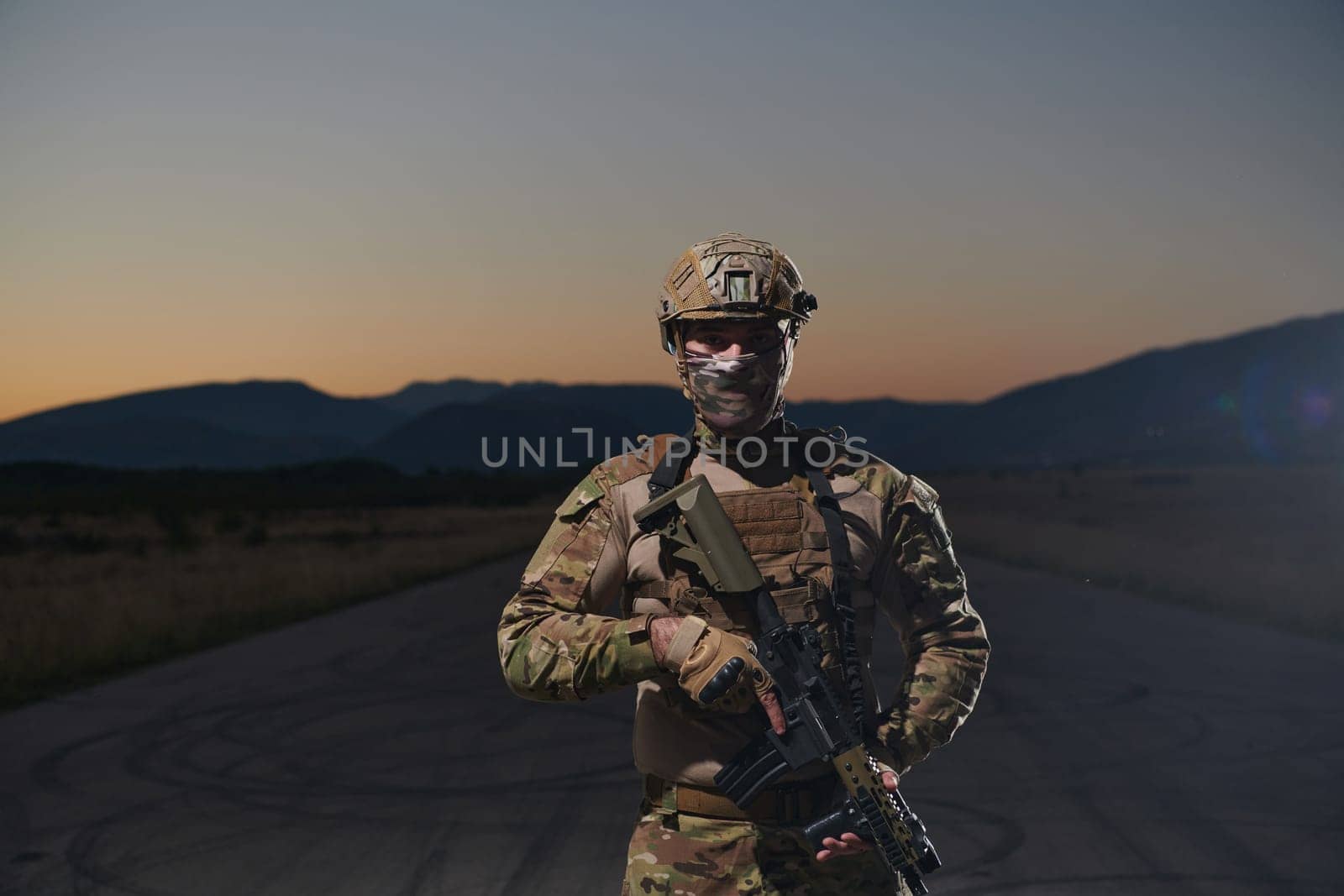 A professional soldier in full military gear striding through the dark night as he embarks on a perilous military mission.