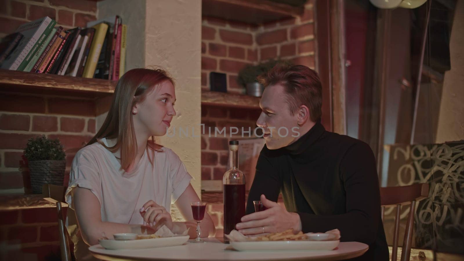 Joyful couple having a romantic date at a fancy restaurant. Media. People celebrating their relationship anniversary