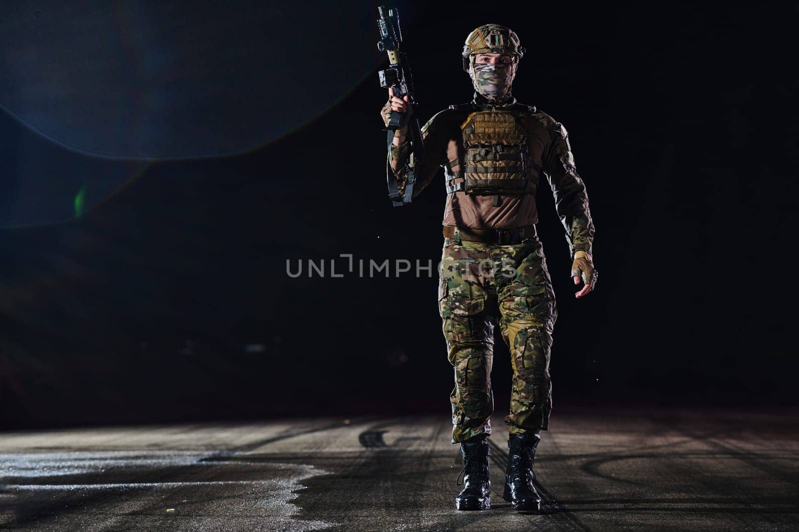 A professional soldier in full military gear striding through the dark night as he embarks on a perilous military mission.