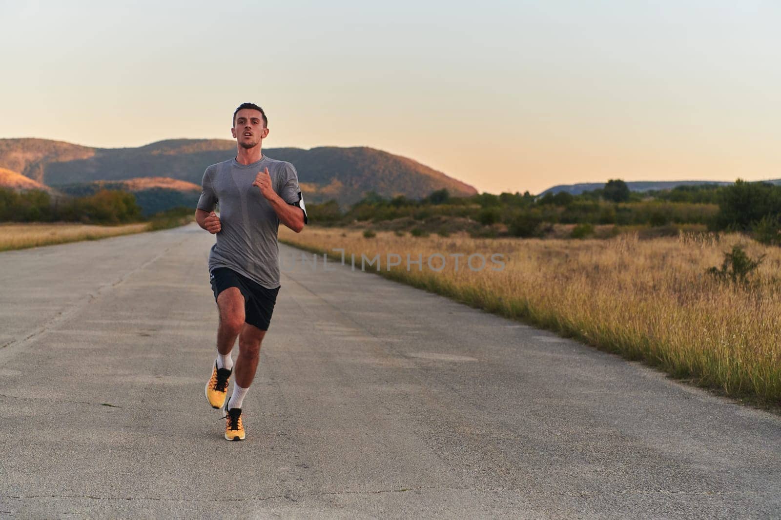 A young handsome man running in the early morning hours, driven by his commitment to health and fitness. High quality photo