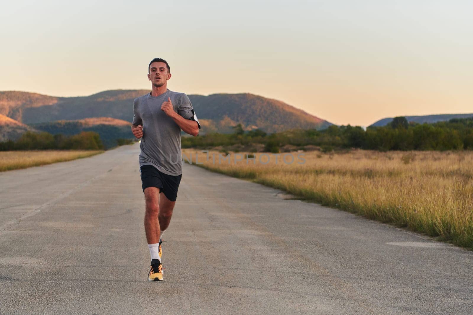 A young handsome man running in the early morning hours, driven by his commitment to health and fitness. High quality photo