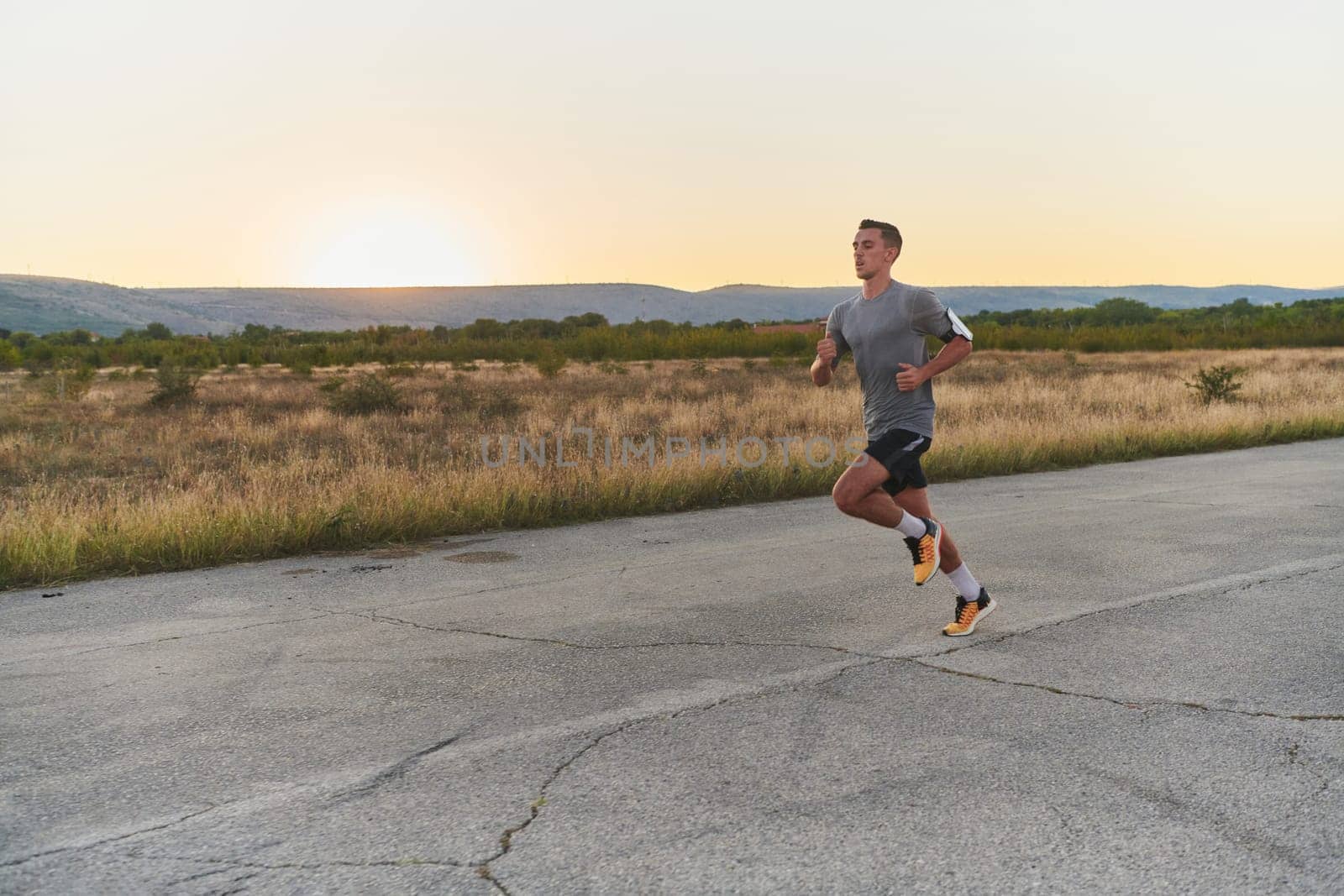 A young handsome man running in the early morning hours, driven by his commitment to health and fitness. High quality photo