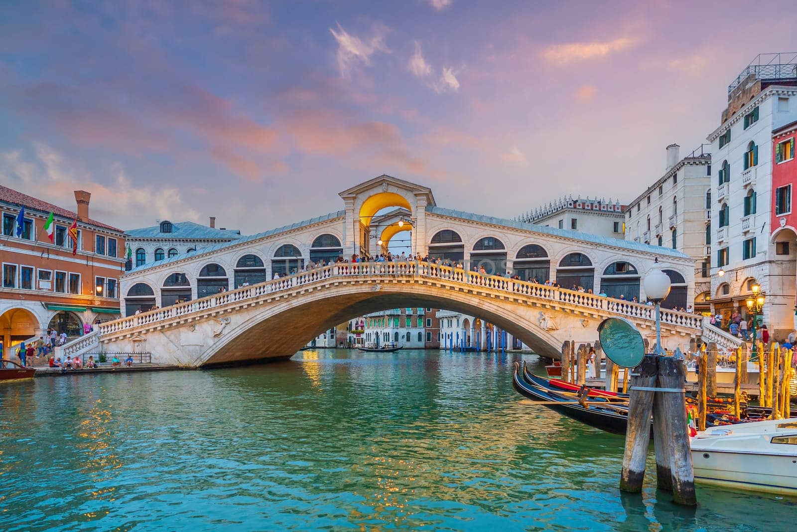 Panoramic view of famous Canal Grande with famous Rialto Bridge at sunset in Venice